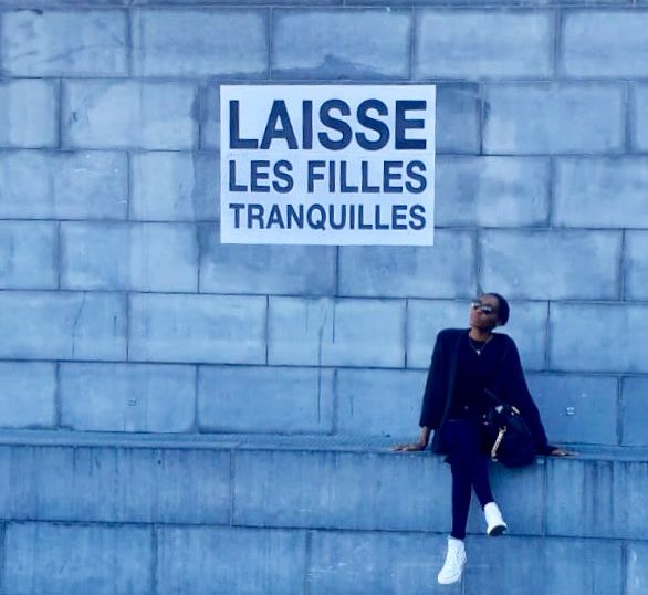 Myself at Mont des Arts by the sign « Laisse Les Filles Tranquillent» (trnsl: Leave Girls Alone)